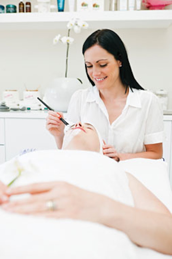 Stock Photo 11474564 Beauty Therapist Paints Facial Mask