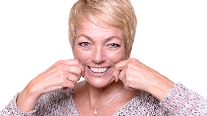 Girl smiling touching face