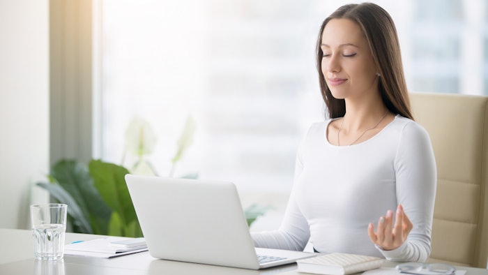 woman meditating at work
