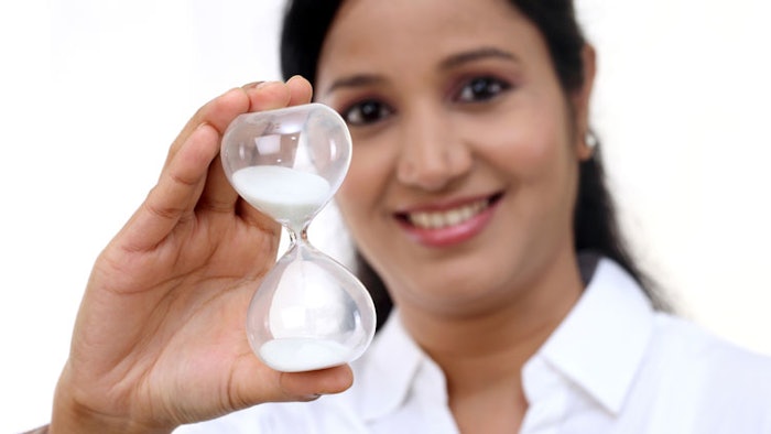 Woman holding hour glass