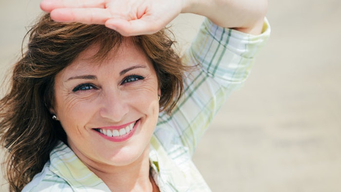 Woman shielding eyes from sun