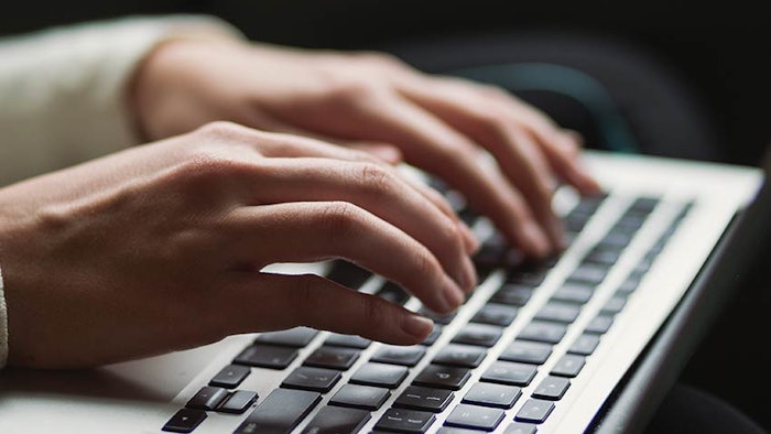 Woman typing on a keyboard