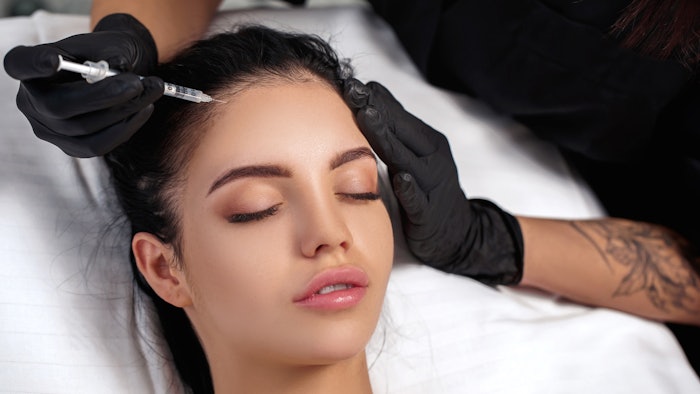 Woman getting injections in forehead