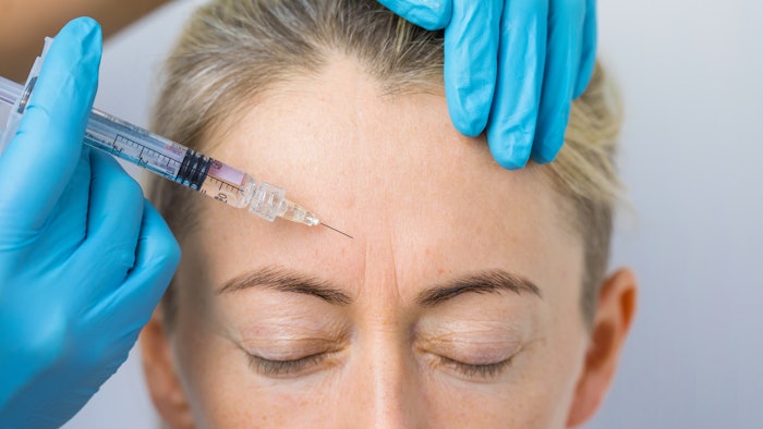 Women receiving filler injection in glabella.