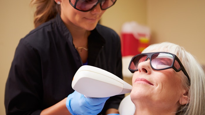 Woman getting laser treatment on face