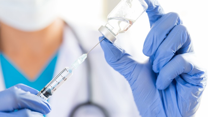 Doctor filling a syringe