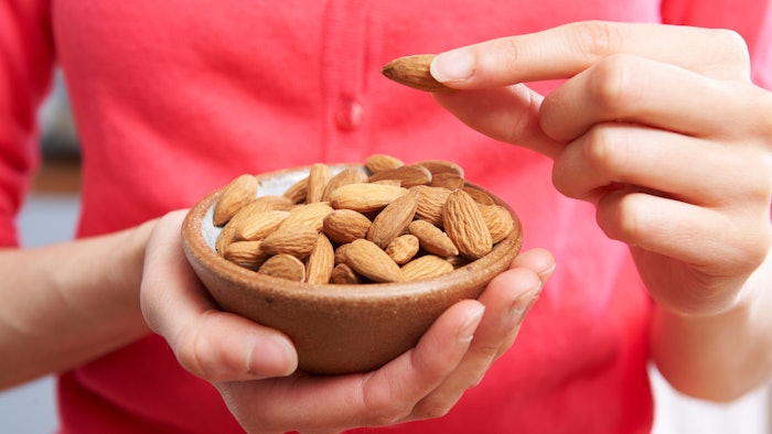 Woman with bowl of almonds