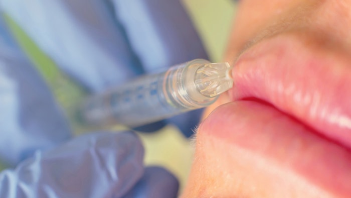 syringe going into lip