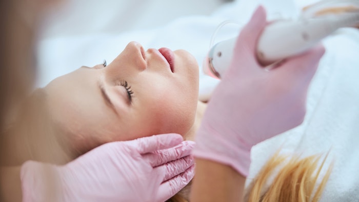 Woman undergoing RF microneedling treatment.