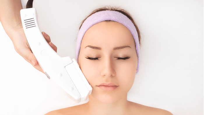 Woman undergoing laser treatment.