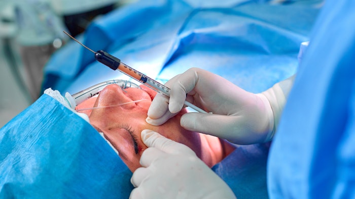 Lipofilling doctor makes fat injections to the patient