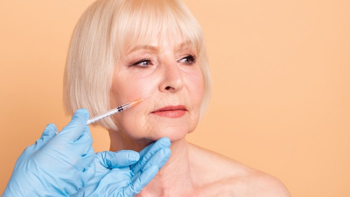 Older woman getting filler in her face