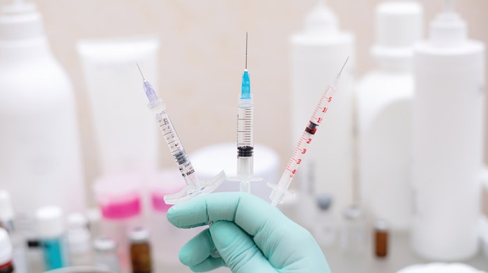 Doctor holding syringes