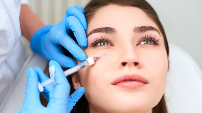 woman getting filler in cheek