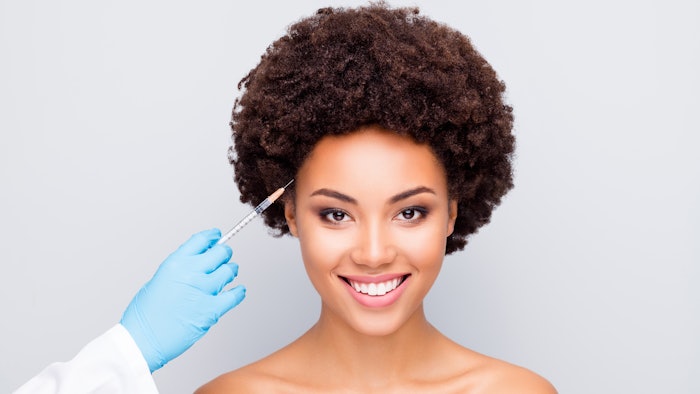 Happy woman getting botox.