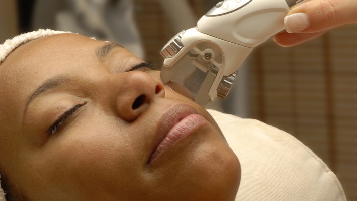 Woman getting laser facial treatment