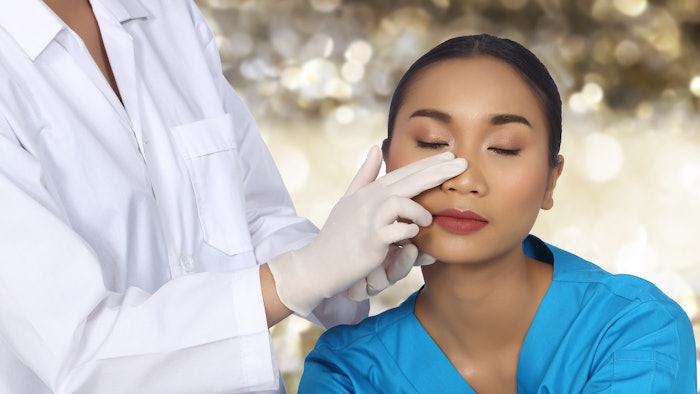 Woman getting nose examined before plastic surgery.