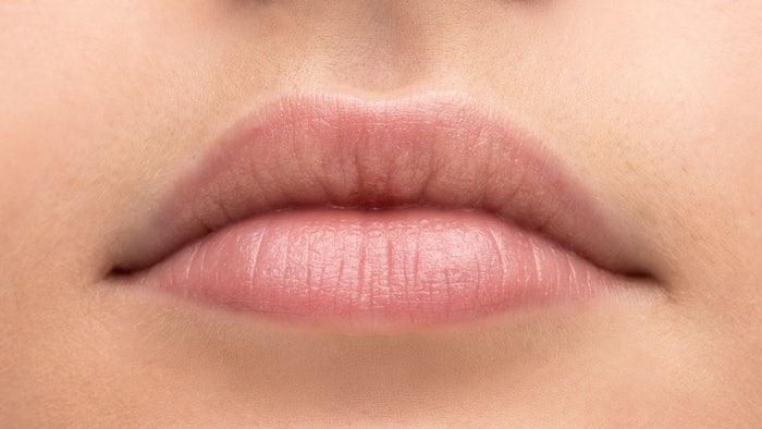 The physicians use a specific phi caliper to identify injection points in the upper and lower lip.