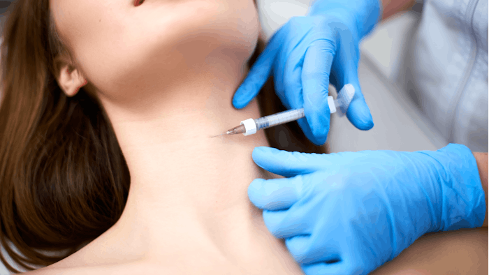 Women receiving Botox injections to her neck.