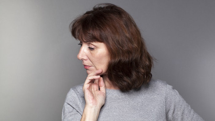 Woman in 50s Holding Chin
