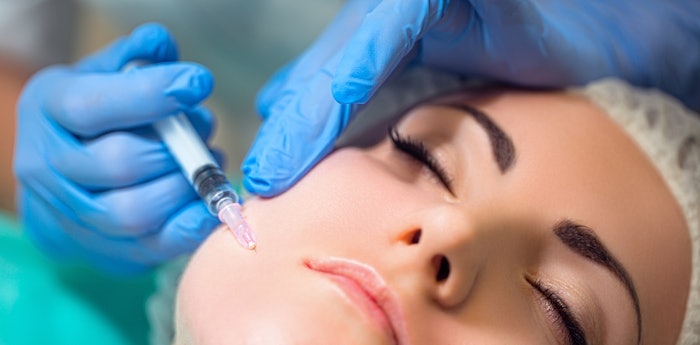 Woman getting facial injection.
