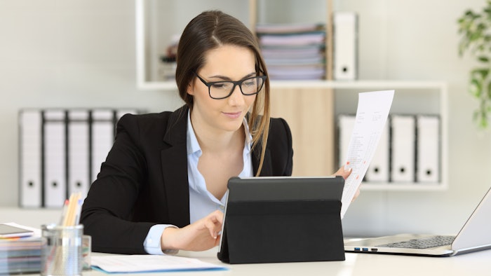 Business woman working at desk.
