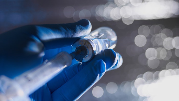 Doctor filling syringe