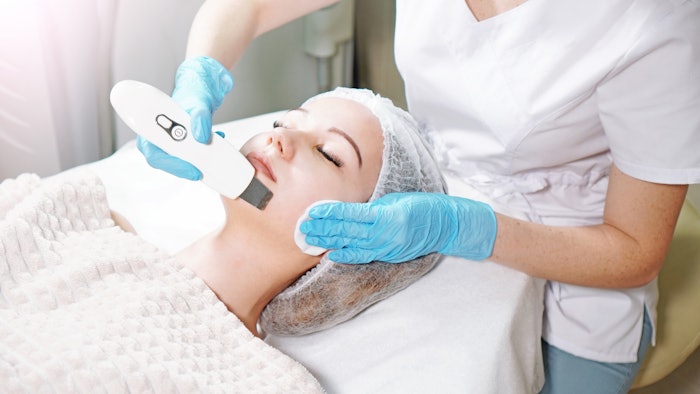 young woman receiving ultrasound facial peel