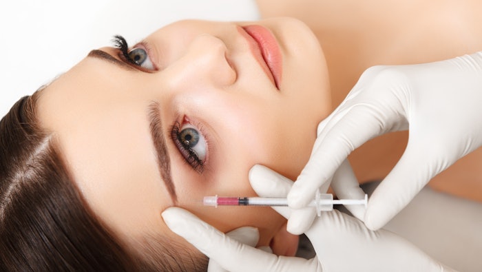 young woman receiving aesthetic injection