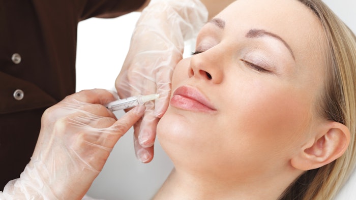 woman receiving lip filler injection