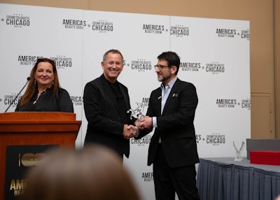 Industry leader David Wagner, owner of Juut Salonspas in Minnesota, Arizona, and California, accepts the Jerry Gordon Salon Business Leadership Award at America's Beauty Show 2023.