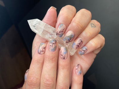 Blue floral nail art with vines