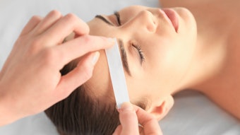 woman getting eyebrows waxed