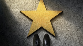 business person standing in front of star