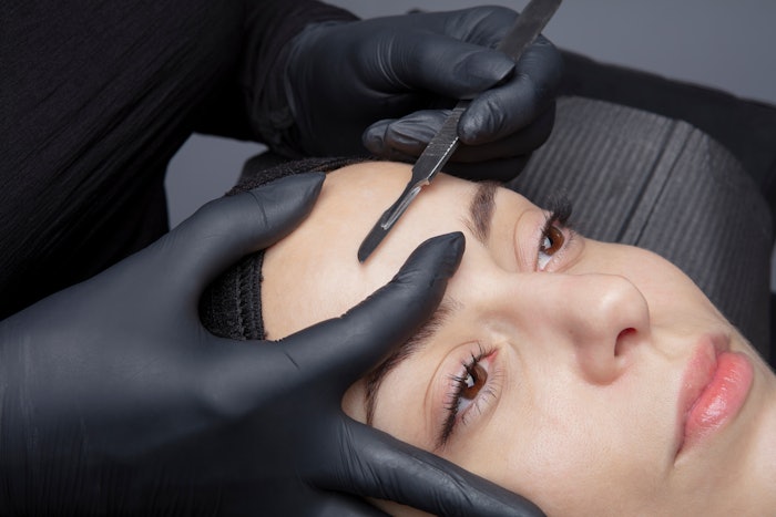 Woman gettig dermaplaning treatment