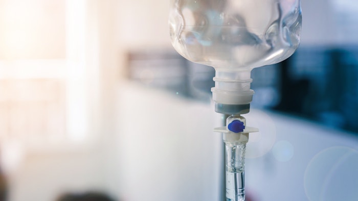 Healthcare concept, Close up of medical drip or IV drip chamber in patient room, Selective focus.
