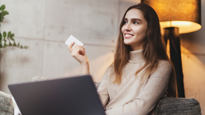 Girl using bank card for buying things online. Retail stores offering bonus cards for customers