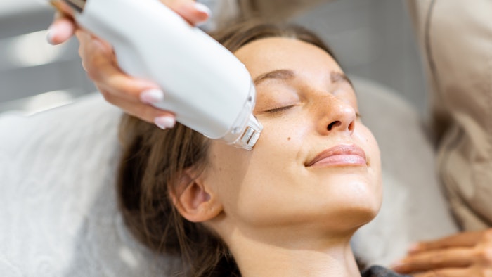 Portrait of a young woman during a facial rejuvenation treatment at medical SPA. LaseMD procedure concept