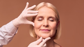 Portrait of an older adult woman with closed eyes evaluated by cosmetic doctor