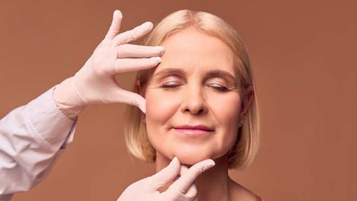 Portrait of an older adult woman with closed eyes evaluated by cosmetic doctor