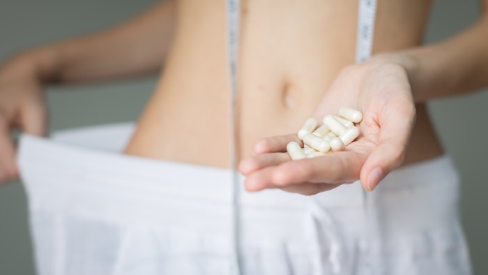 Diet pills. A woman successful with weight loss. Beauty and health.