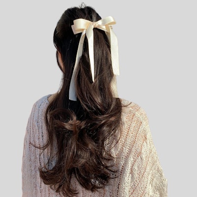 'The half-up, half-down hairstyle has always been a classic and elegant choice. A current, stylish trend involves elevating this style by adding a bow as the perfect accessory.'