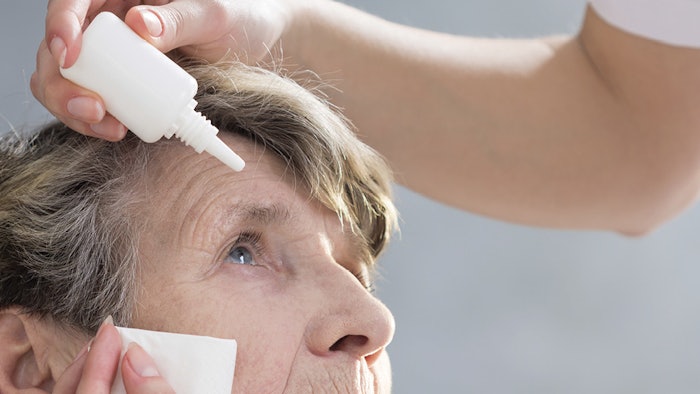 Nurse putting eye drops