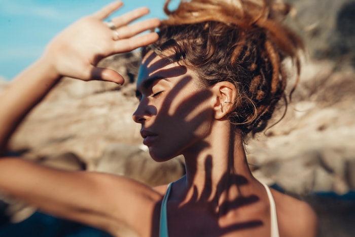 Woman Shielding Eyes from Sun