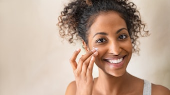 Beautiful girl applying face cream