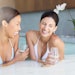 Women laughing in hot tub at spa