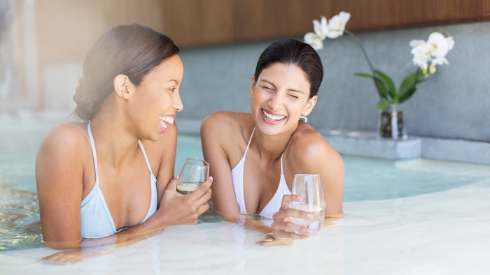Women laughing in hot tub at spa