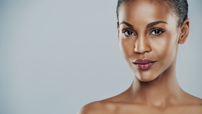 Woman with seductive expression on gray background