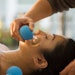 Young Woman receiving facial rejuventation cupping in spa wellness center