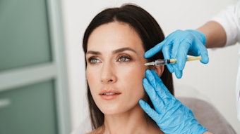 Photo of beautiful woman getting mesotherapy treatment in face
